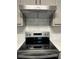 Stainless steel range with electric cooktop and overhead vent at 360 Chestnut Dr, Covington, GA 30016