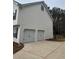 Two-car garage with attached driveway and additional outdoor space at 360 Chestnut Dr, Covington, GA 30016