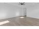 Large bedroom with light wood floors and a ceiling fan, offering ample space at 550 Versailles Dr, Auburn, GA 30011