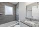 Modern bathroom with granite countertop, tiled shower, and white vanity at 2452 Semmes St, Atlanta, GA 30344