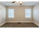 Bedroom with neutral walls, carpeting, and two windows with blinds at 2452 Semmes St, Atlanta, GA 30344