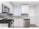 Renovated kitchen, granite countertops, stainless steel appliances, and gray tile backsplash at 2452 Semmes St, Atlanta, GA 30344