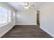 Living room with dark gray vinyl flooring, ceiling fan, and neutral walls at 2452 Semmes St, Atlanta, GA 30344