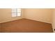 Well-lit bedroom with large window and carpet flooring at 8178 Lochley Dr, Fairburn, GA 30213