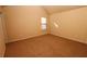 Spacious carpeted bedroom with large window and neutral walls at 8178 Lochley Dr, Fairburn, GA 30213