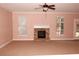 Spacious living room featuring a fireplace and neutral carpeting at 8178 Lochley Dr, Fairburn, GA 30213