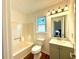 Clean bathroom with a tub, toilet and vanity at 3945 Peninsula Ct, Lawrenceville, GA 30044