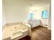 Bathroom boasts a large bathtub and double vanity at 3945 Peninsula Ct, Lawrenceville, GA 30044
