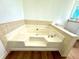 Soaking tub with tiled surround at 3945 Peninsula Ct, Lawrenceville, GA 30044