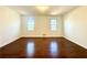 Large bedroom with hardwood floors and two windows at 3945 Peninsula Ct, Lawrenceville, GA 30044