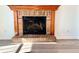 Brick fireplace with wood mantel in a living room at 3945 Peninsula Ct, Lawrenceville, GA 30044