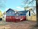 Back of house with deck and fenced backyard at 3945 Peninsula Ct, Lawrenceville, GA 30044
