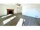 Hardwood floor living room with fireplace and access to dining room at 3945 Peninsula Ct, Lawrenceville, GA 30044