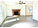 Spacious living room with hardwood floors and brick fireplace at 3945 Peninsula Ct, Lawrenceville, GA 30044