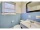 Small bathroom with light blue tile and vanity at 1743 Marcel Sw Ave, Atlanta, GA 30311