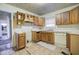 Kitchen with wood cabinets and vinyl flooring needing updates at 1743 Marcel Sw Ave, Atlanta, GA 30311