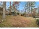 Large backyard with a sloped terrain and mature trees at 2418 Brookdale Ne Dr, Atlanta, GA 30345