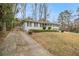 Side view of a gray brick ranch home with a long driveway at 2418 Brookdale Ne Dr, Atlanta, GA 30345