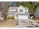 Two-story house with stone accents and a two-car garage at 3039 Sable Run Rd, Atlanta, GA 30349