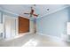 Bedroom with light blue walls, exposed brick wall, and ceiling fan at 1490 Lee Peters Rd, Loganville, GA 30052