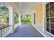 Covered porch with white columns and views of the backyard at 1490 Lee Peters Rd, Loganville, GA 30052