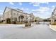 Gated entrance to a community of townhouses with landscaping and a paved road at 3556 Parkside Way, Brookhaven, GA 30319