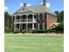 Brick house with columns and large lawn at 6315 Sturbridge Ln, Cumming, GA 30040