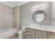 Modern bathroom with a soaking tub, gray tile, and a floating vanity at 1099 North Ne Ave # 13, Atlanta, GA 30307