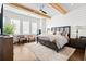 Spacious main bedroom with wood beams, a large bed, and plenty of natural light at 6750 Avis Walk, Alpharetta, GA 30005