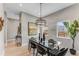 Modern glass dining table with six chairs, stylish lighting, and hardwood floors at 1099 North Ne Ave # 12, Atlanta, GA 30307