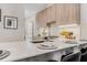 Modern kitchen with white quartz countertops and wood cabinets at 1099 North Ne Ave # 8, Atlanta, GA 30307