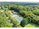 Aerial view showing tennis court, pool, and surrounding green space at 1022 Fieldstone Dr, Canton, GA 30114