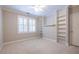 Well-lit bedroom with carpet, window shutters and built-in shelves at 5877 Riverstone Cir # 17, Atlanta, GA 30339