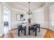 Bright dining room features hardwood floors, chandelier, and built-in cabinetry at 5877 Riverstone Cir # 17, Atlanta, GA 30339