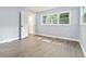 Bright bedroom with light purple walls and vinyl flooring, and an ensuite bathroom at 4623 Lawrenceville Hwy, Tucker, GA 30084