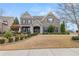 Two-story brick home with a stone facade and landscaped yard at 5665 Bridleton Xing, Suwanee, GA 30024