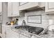 Kitchen detail with gas cooktop and granite countertops at 5665 Bridleton Xing, Suwanee, GA 30024