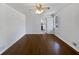 Living room with hardwood floors and view into kitchen at 6041 Morrow Cv, Morrow, GA 30260