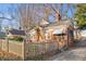 Brick home with a charming front porch, picket fence, and driveway at 1015 Deckner Sw Ave, Atlanta, GA 30310