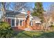 Brick home with a charming front porch and well-maintained lawn at 1015 Deckner Sw Ave, Atlanta, GA 30310