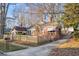 Brick house with a red awning, wooden fence, and driveway at 1015 Deckner Sw Ave, Atlanta, GA 30310