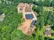 Aerial view of a large property, including a house and several outbuildings at 1730 Etchison Spur, Loganville, GA 30052