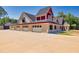 Brick home with a three-car garage and red trim at 1730 Etchison Spur, Loganville, GA 30052
