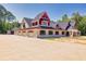 Brick house under construction, showcasing a red and white exterior and four-car garage at 1730 Etchison Spur, Loganville, GA 30052