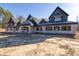 Brick house with a large front porch and a dark-colored roof at 1730 Etchison Spur, Loganville, GA 30052