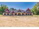 Brick house with a red accented roof and large front porch at 1730 Etchison Spur, Loganville, GA 30052