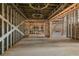 Open floor plan under construction with high ceilings and large windows at 1730 Etchison Spur, Loganville, GA 30052