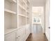 Bright hallway with built-in shelves and hardwood floors at 3862 Stratford Park Ne Dr, Atlanta, GA 30342