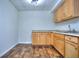 Basement kitchenette with wood cabinets and flooring at 109 Enclave Ct, Powder Springs, GA 30127