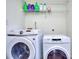 Laundry room with washer and dryer, and shelving for storage at 109 Enclave Ct, Powder Springs, GA 30127